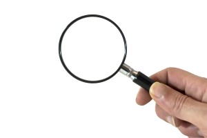 Research and Answers: Magnifying Glass held by a hand